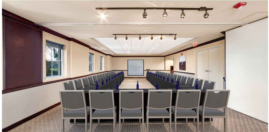 Classroom-style meeting room with rows of chairs facing an Atlantic Hotel & Spa projection screen