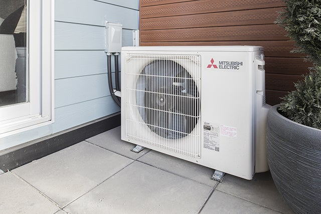 Mitsubishi Electric ductless mini split heat pump outdoor unit installed on a patio