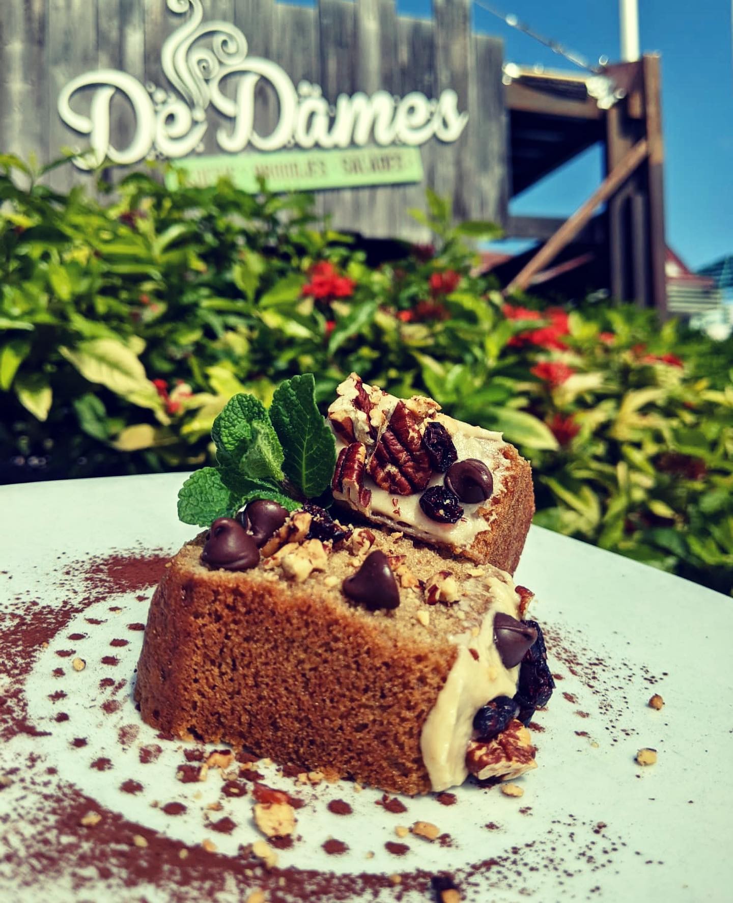 People enjoying food at De Dames