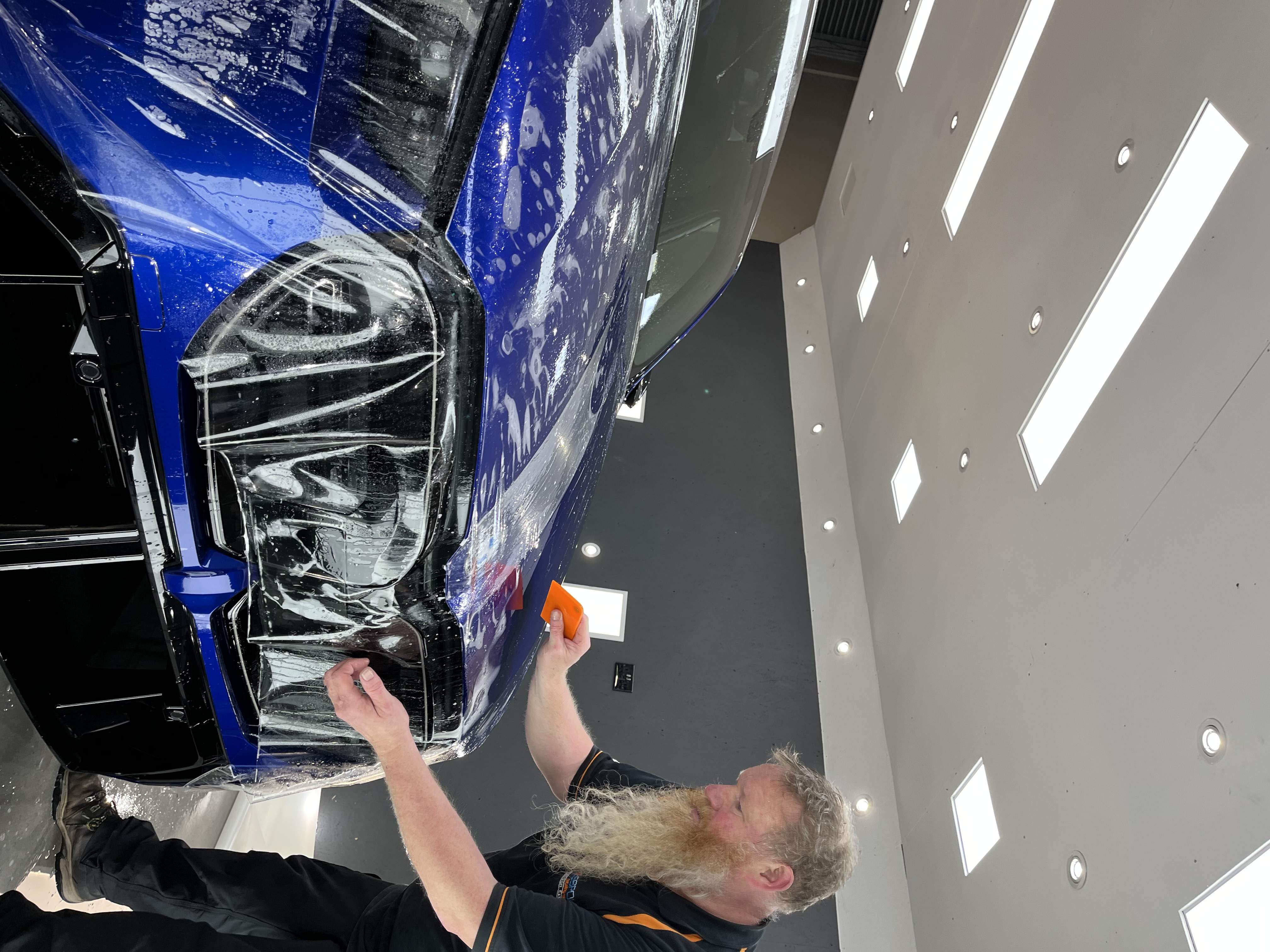 Professional PPF application on a blue car