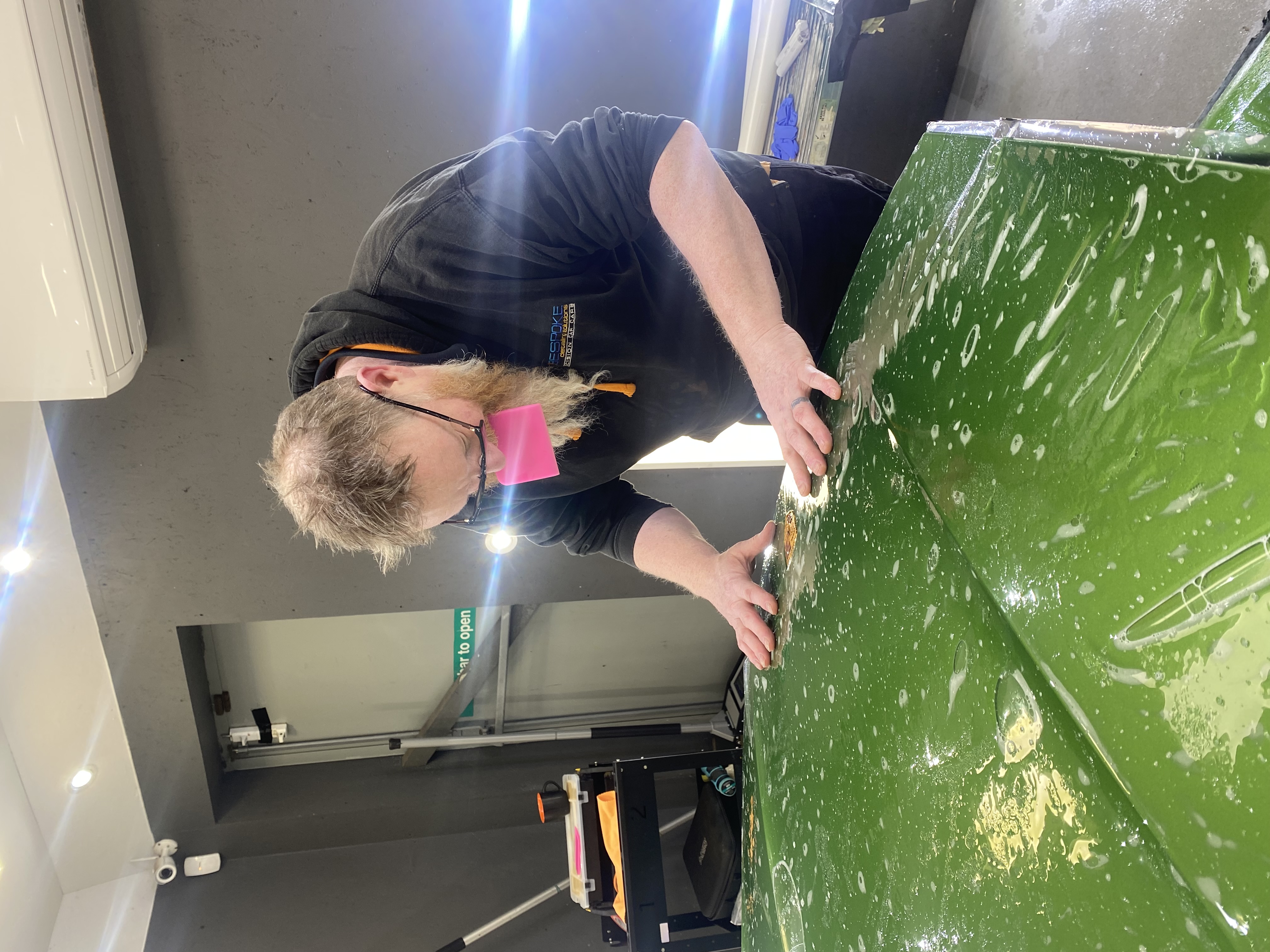 Applying XPEL PPF to a green vehicle hood