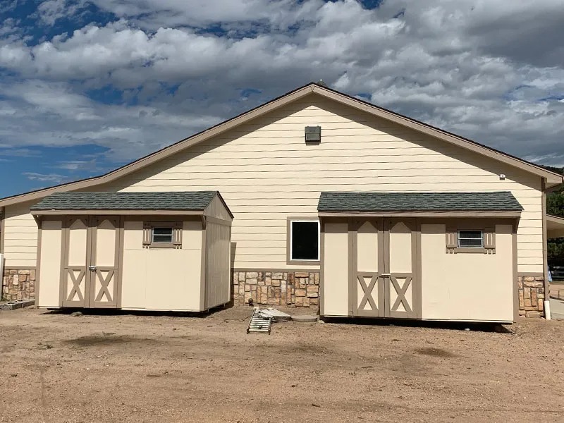 Commercial exterior painting project with sheds