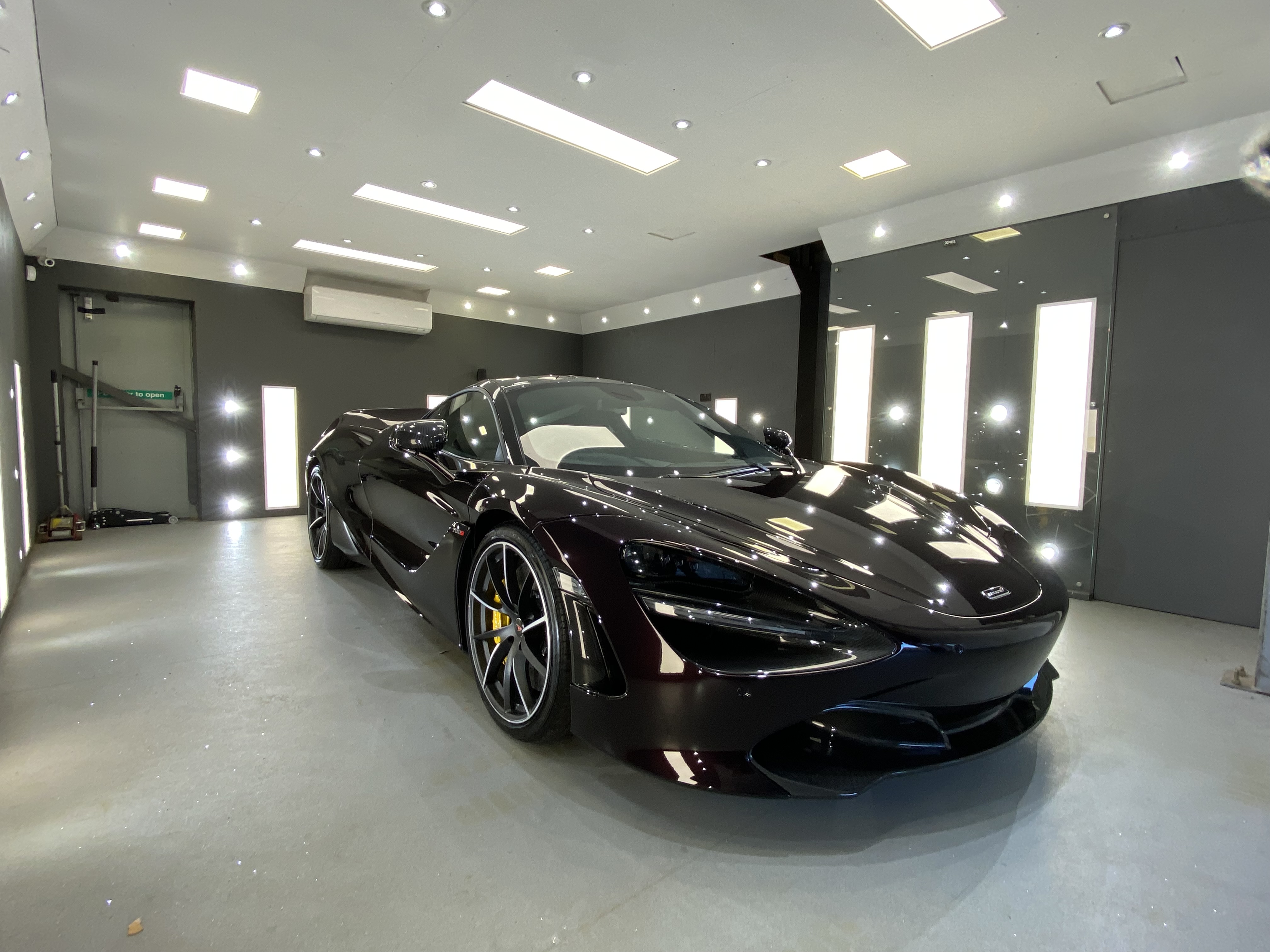 Black McLaren supercar in studio