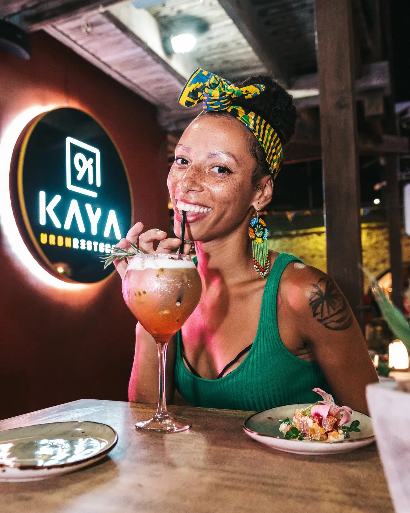 Smiling Guest with Signature Cocktail at Kaya 91