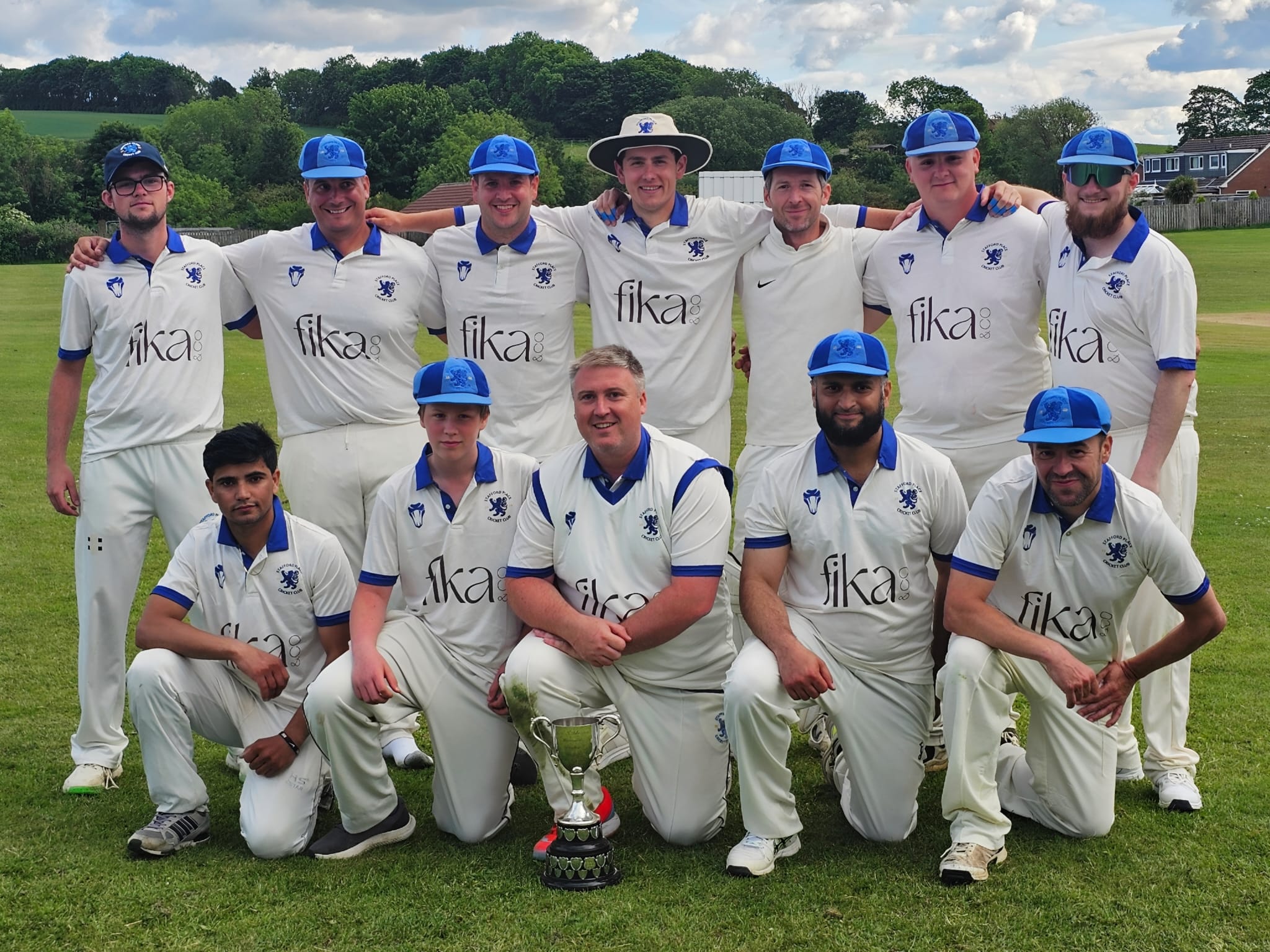 Cricket team in white kits with blue custom bucket hats