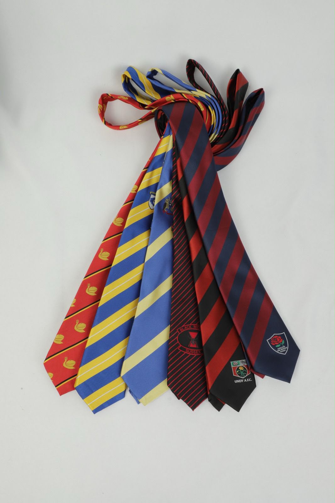 Bold striped custom club ties in red, blue, yellow and burgundy