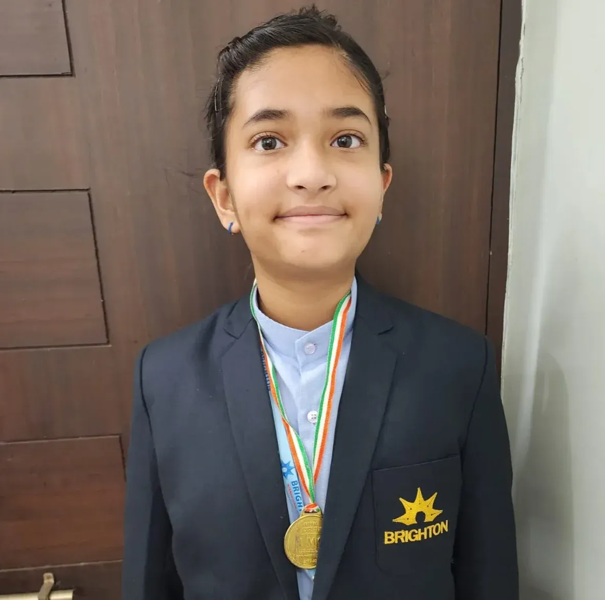 Bela, Grade 6 MathFit Kid in Brighton school blazer with gold medal