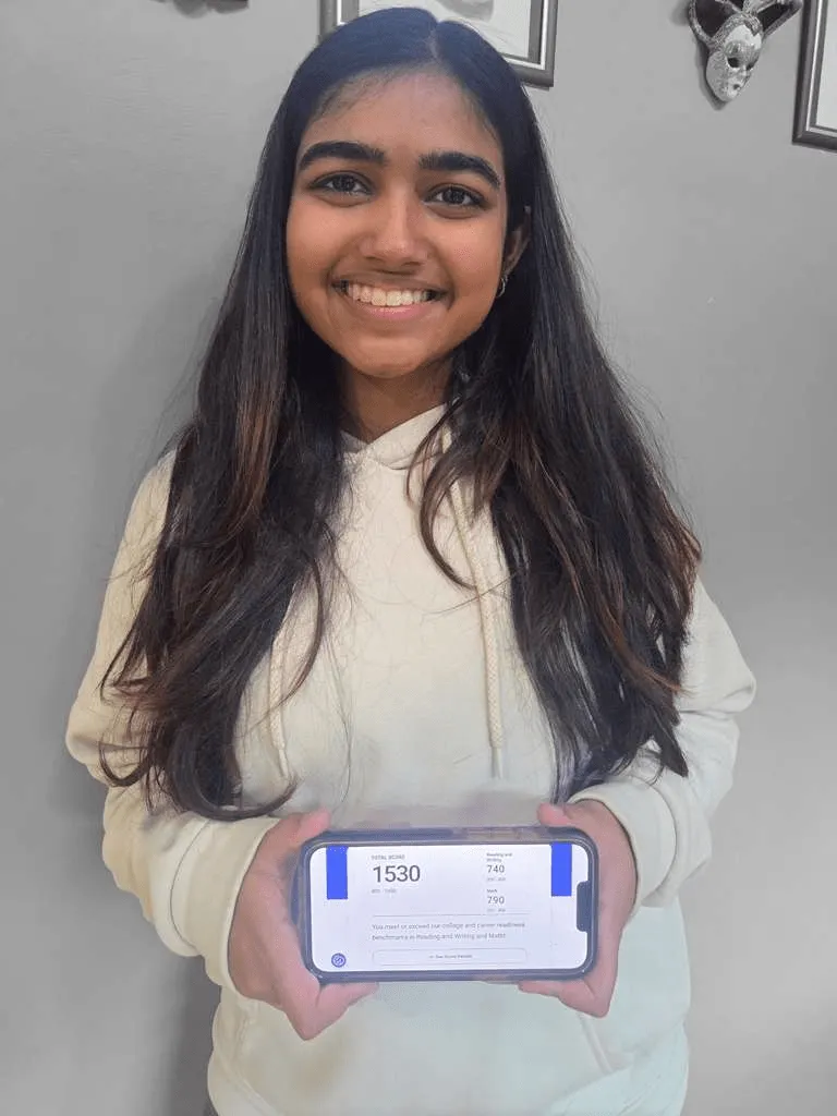 Vanya, MathFit Kid holding her SAT 1530 score (790 Math)