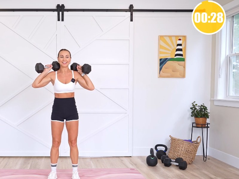 Kathleen leading a strength class with the class timer on screen