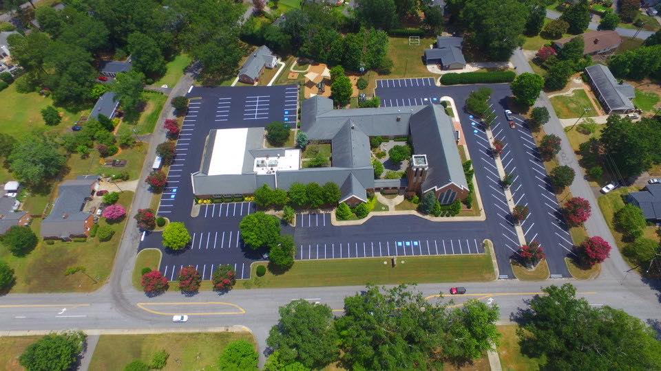 Completed commercial parking lot with fresh asphalt and line striping