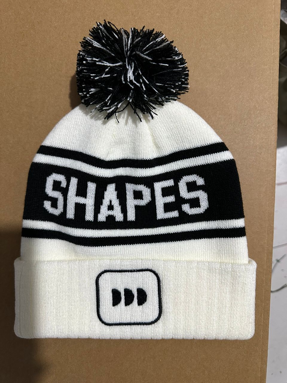 Shapes custom white and black bobble hat with black DD logo patch