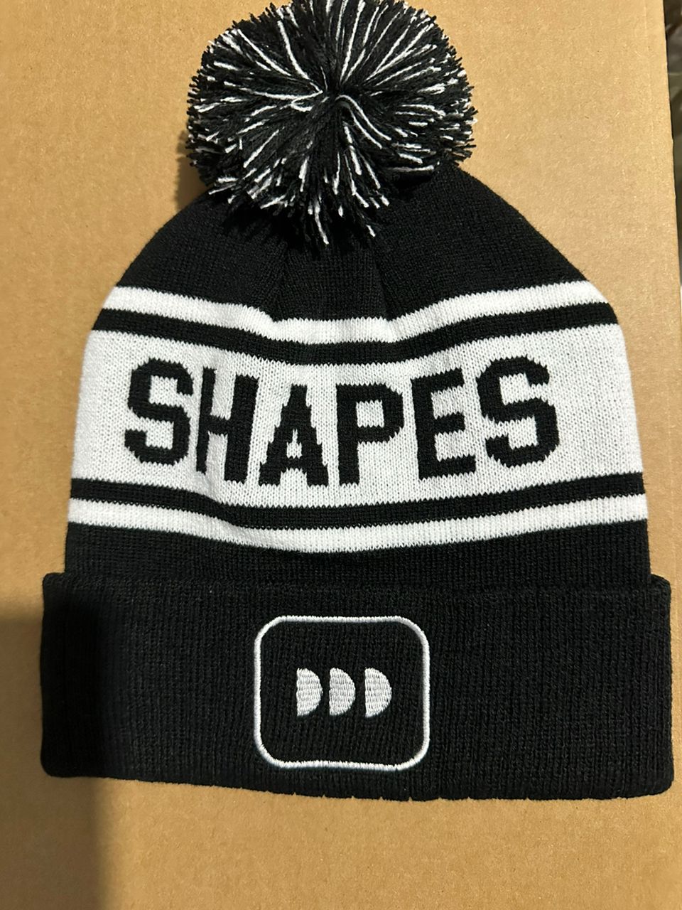 Shapes custom black and white bobble hat with white DD logo patch