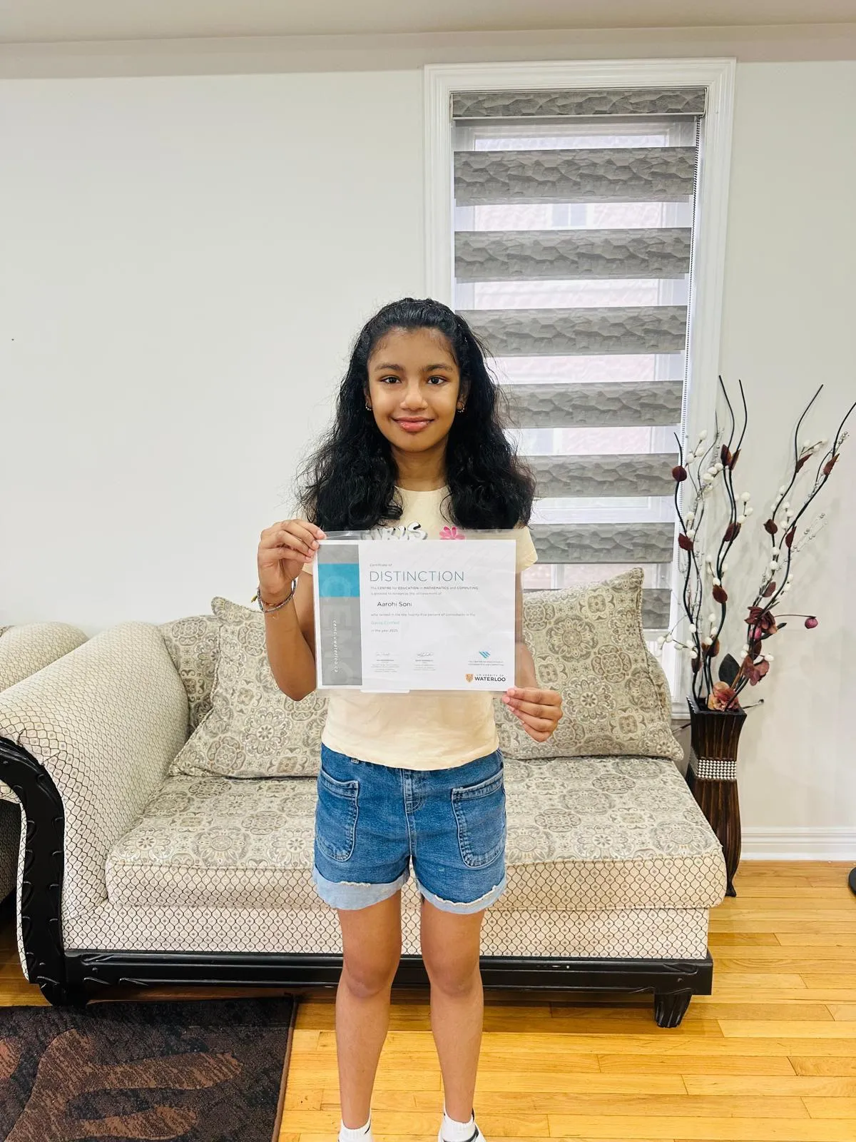 Aarohi, Cuemath high school student, holding her Distinction certificate