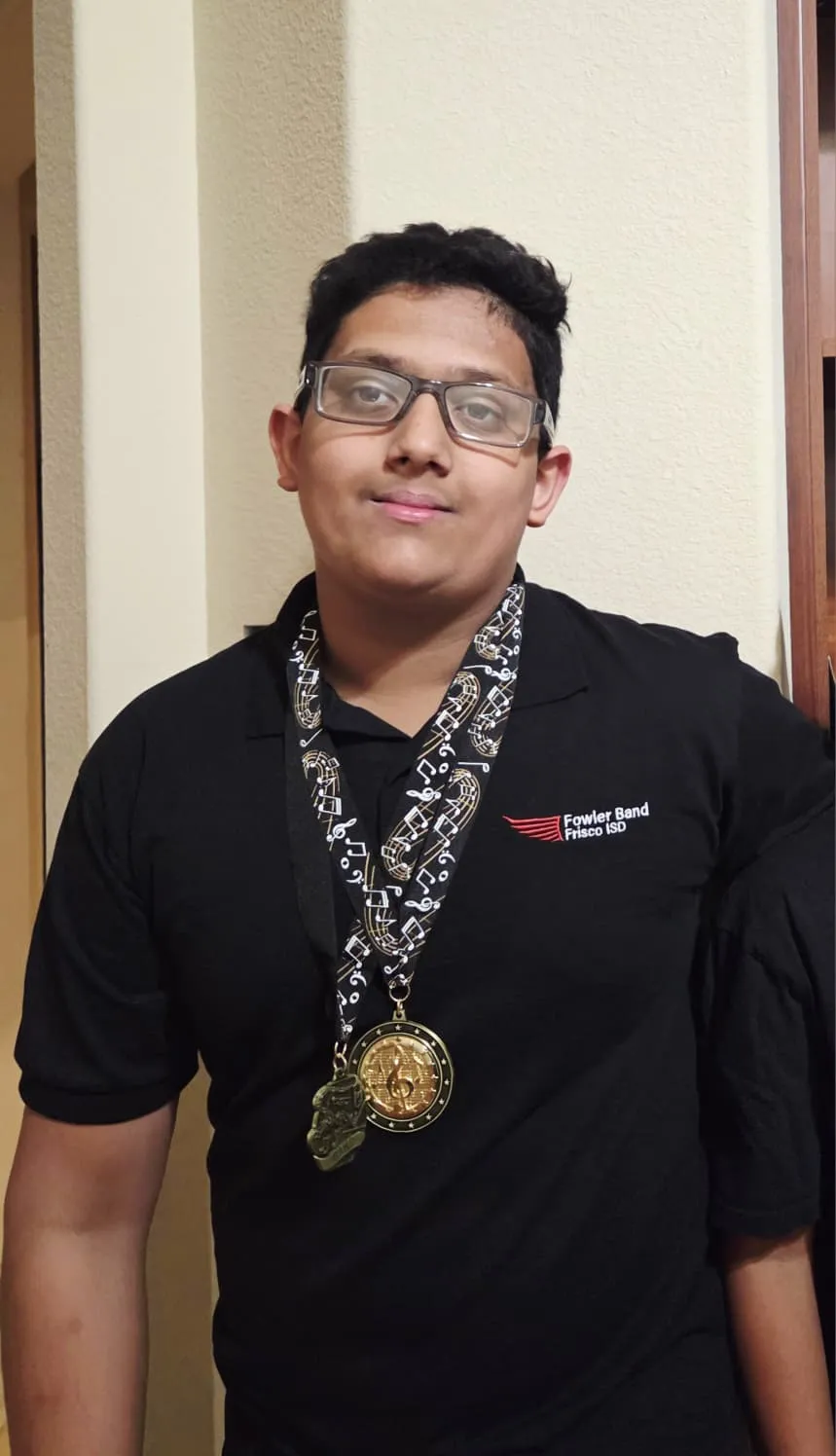 Ishan, Grade 9, wearing Fowler Band medal and STAAR achievement lanyard