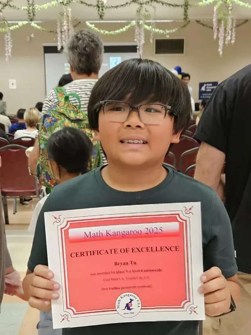 Bryan Tu, Grade 5, holding his Math Kangaroo 2025 Certificate of Excellence