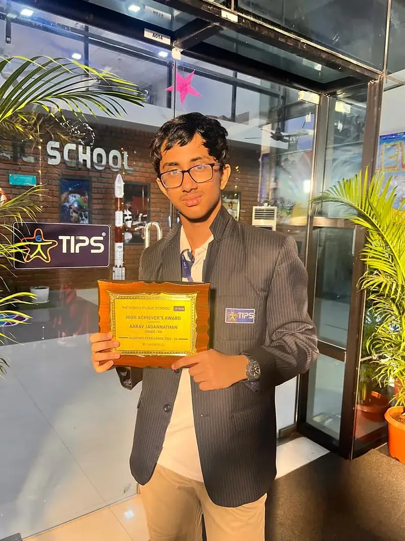 Aarav Jagannathan, Grade 9, holding his High Achiever's Award at TIPS school