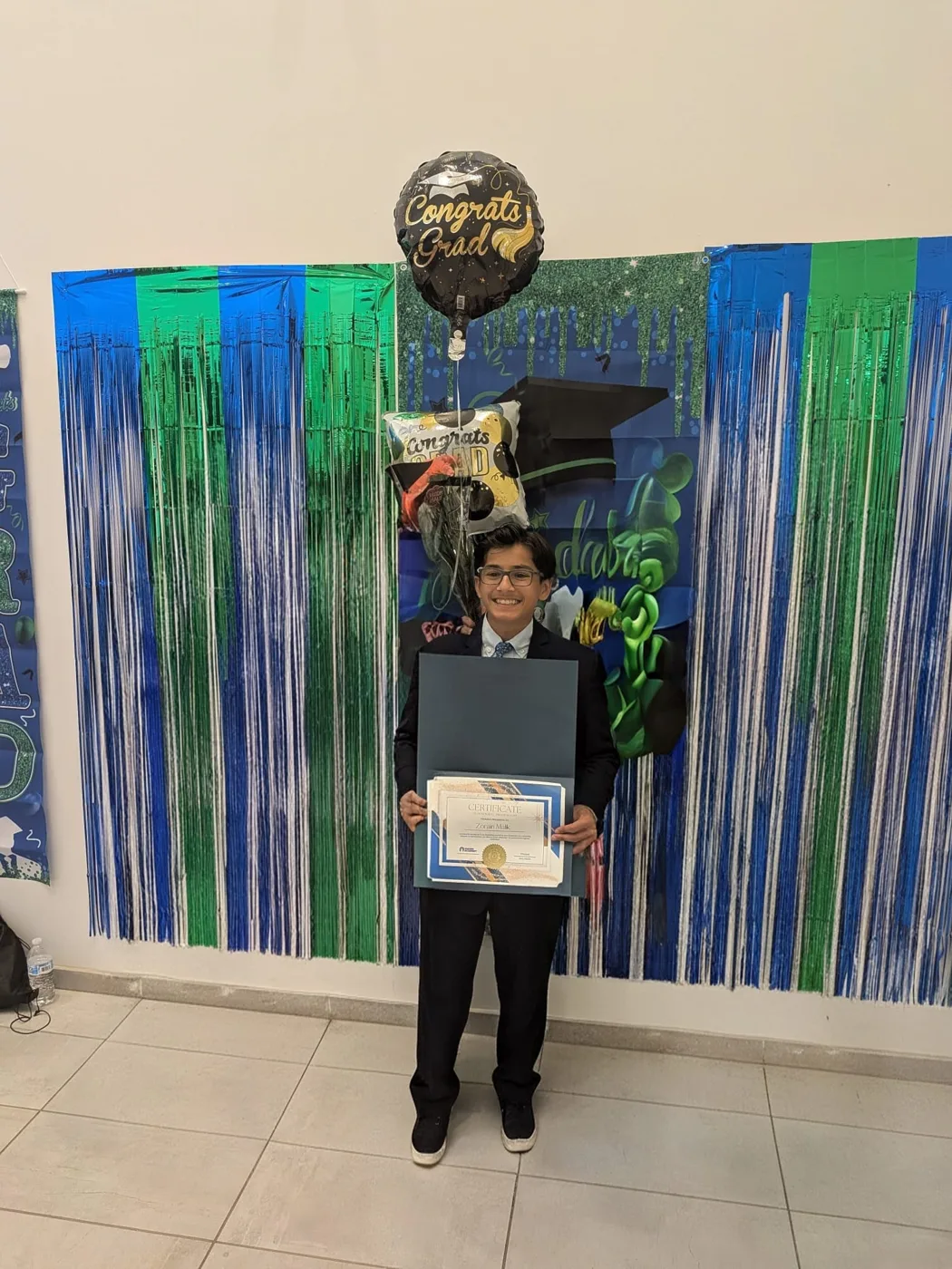 Zorain, Grade 8 Cuemath student, holding his perfect-score certificate at graduation