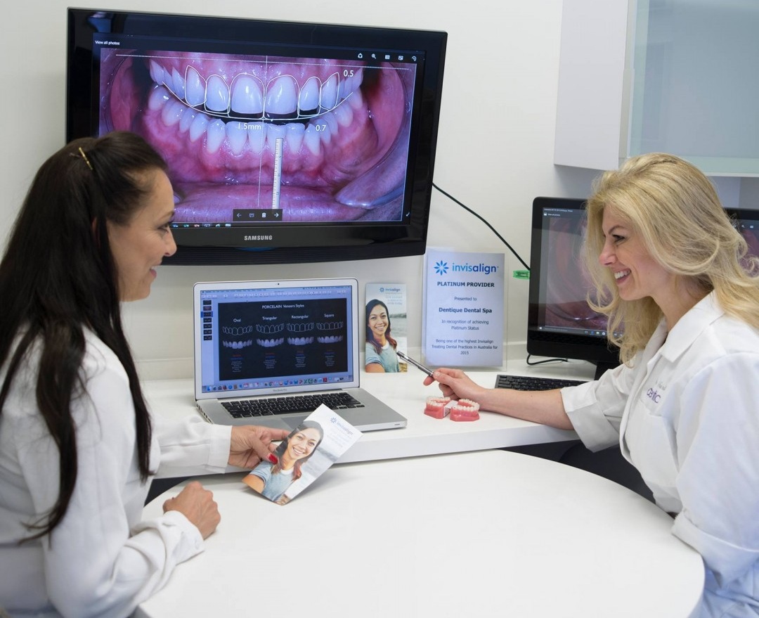 Dentist reviewing a smile preview with a patient during a consultation