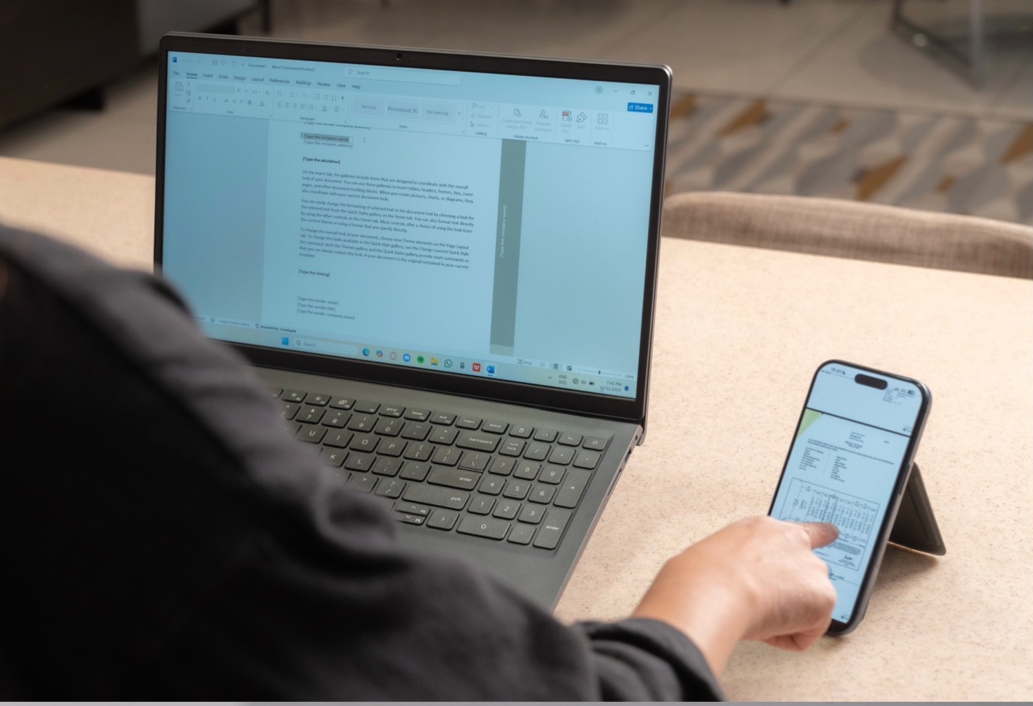 MagShift holding a phone at a comfortable viewing angle next to a laptop
