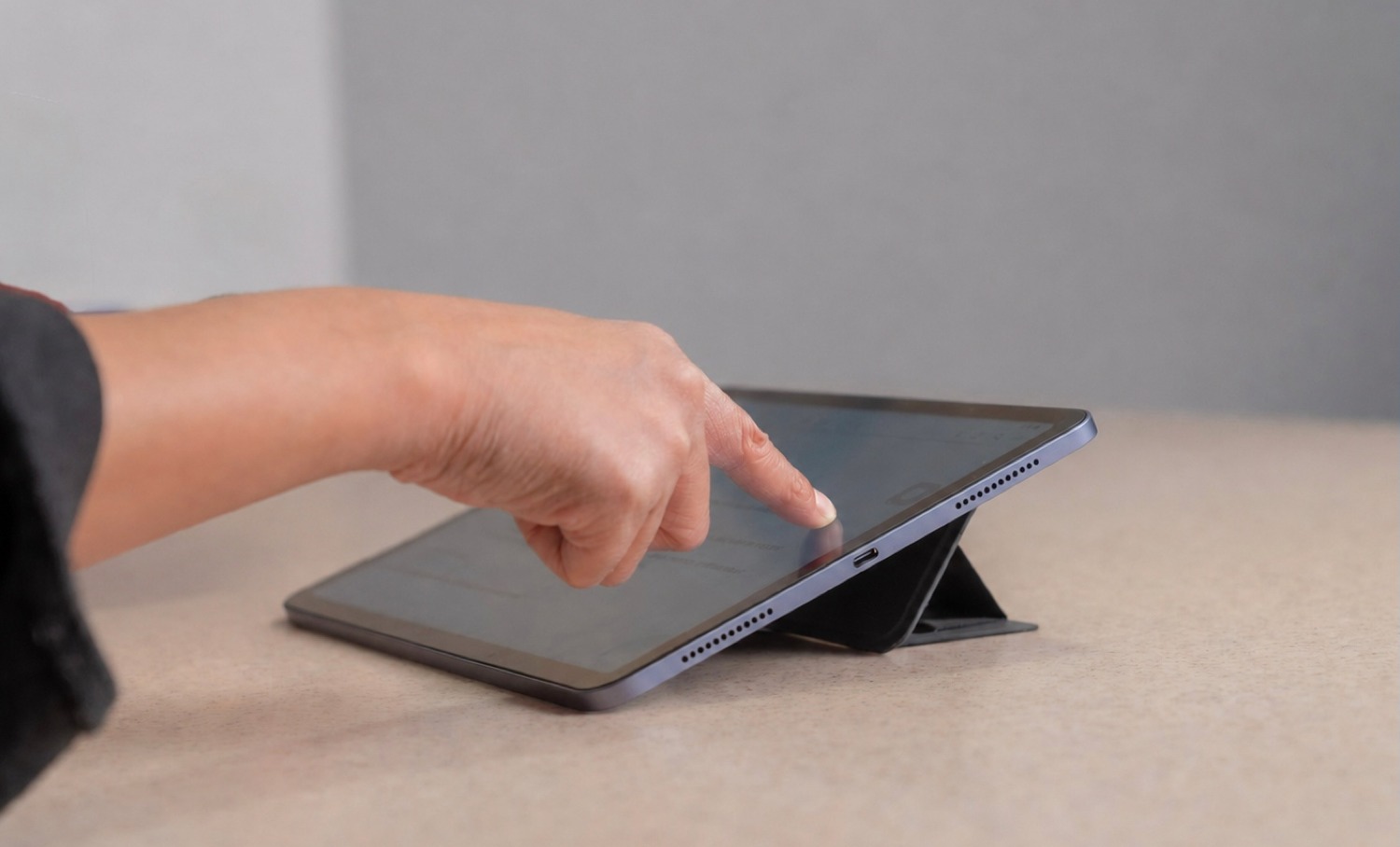 MagShift in tablet stand mode with hand interacting with the screen