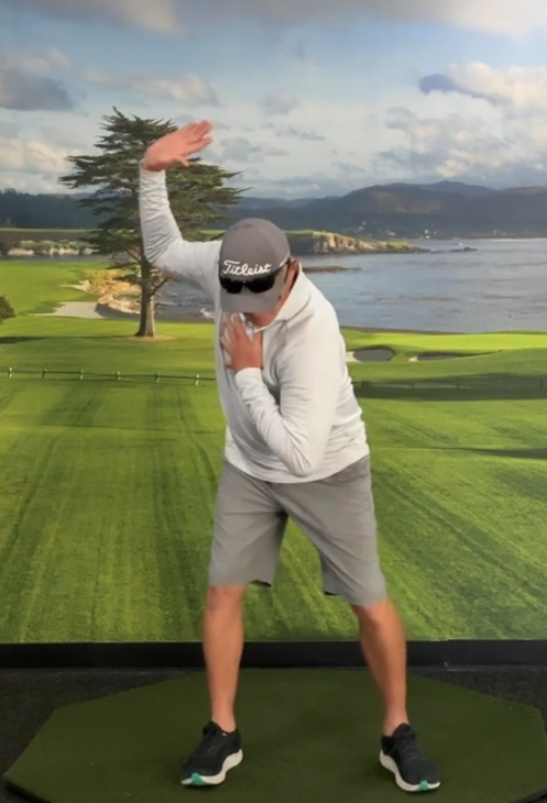 Golfer performing a body movement drill on the practice mat
