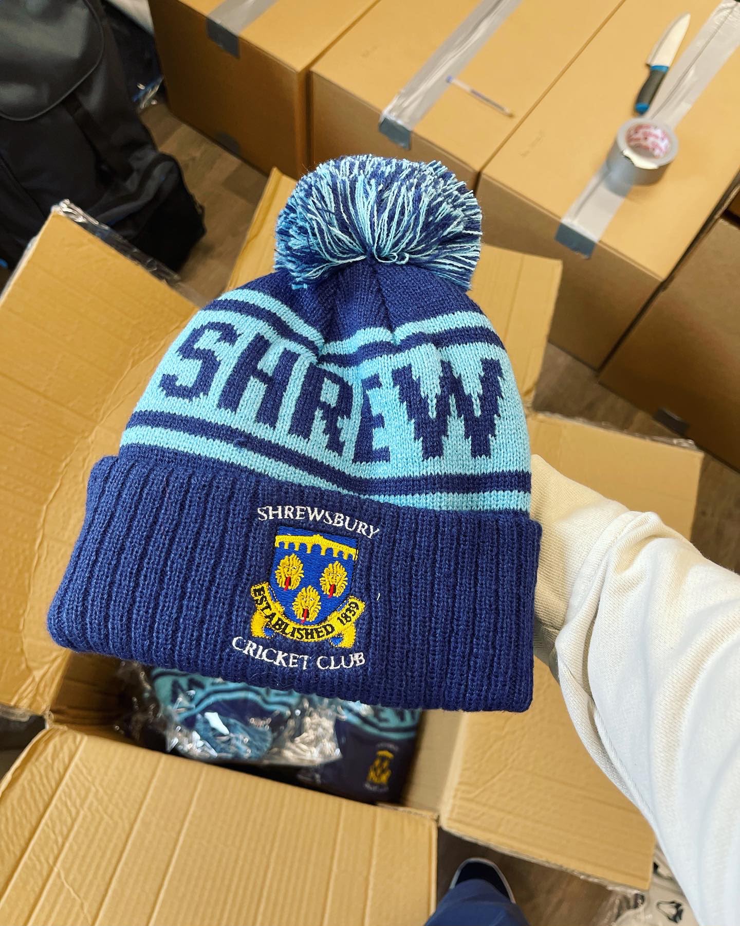 Shrewsbury Cricket Club custom navy and sky blue bobble hat with SHREWSBURY CRICKET CLUB shield patch