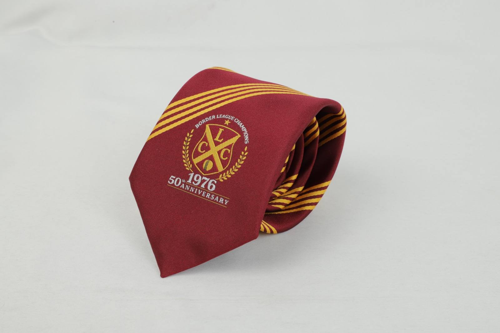 Custom maroon tie with yellow stripes and Border League Champions 50th Anniversary badge
