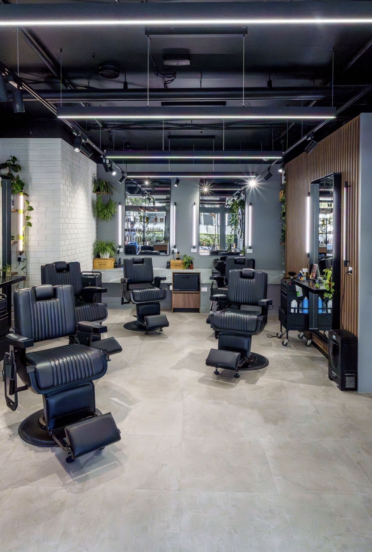 Barbers of Belgium studio interior with premium black leather chairs and industrial lighting