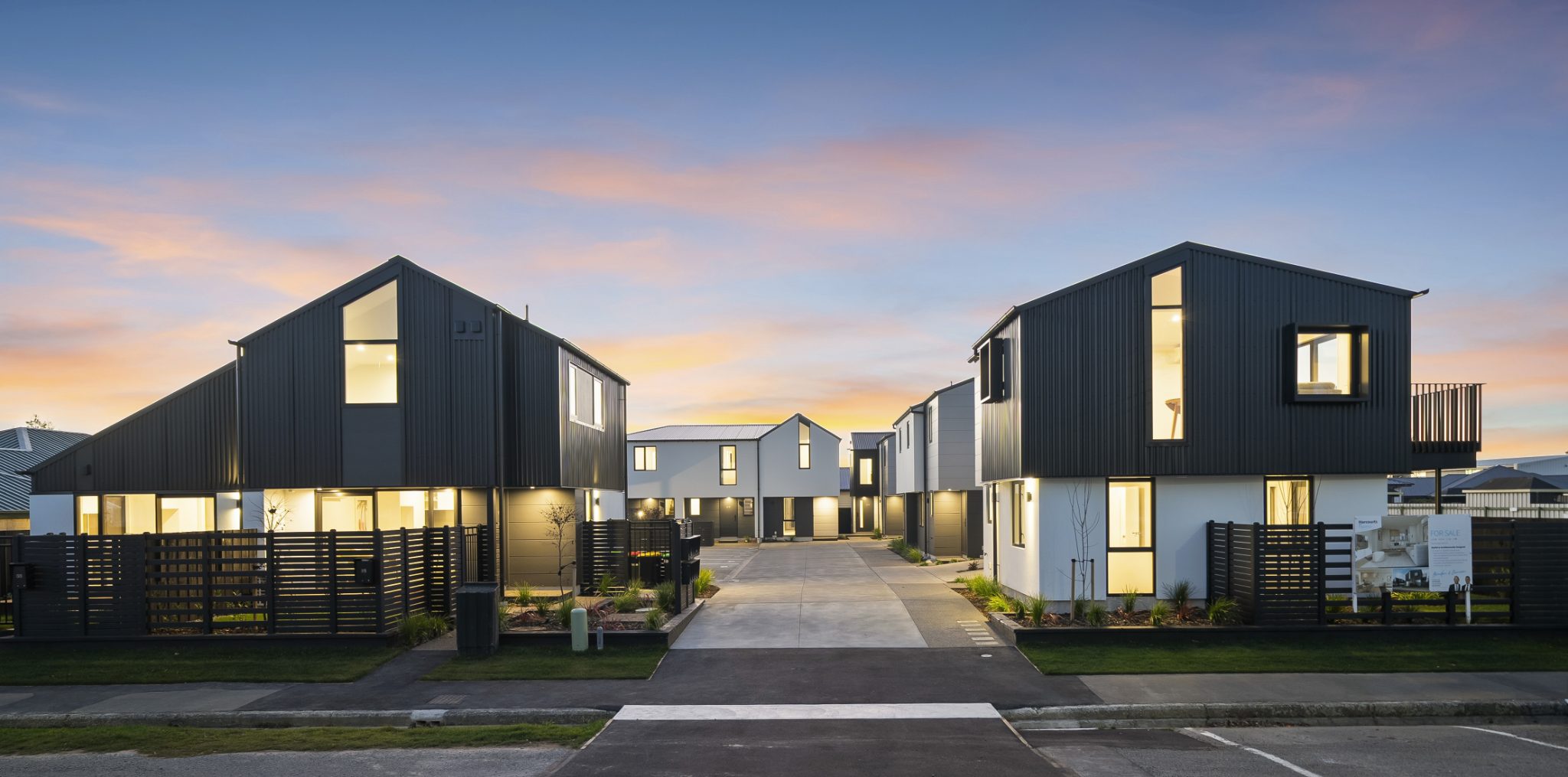Central driveway at 15 Silvester Street, Woolston, with completed townhouses on both sides at dusk